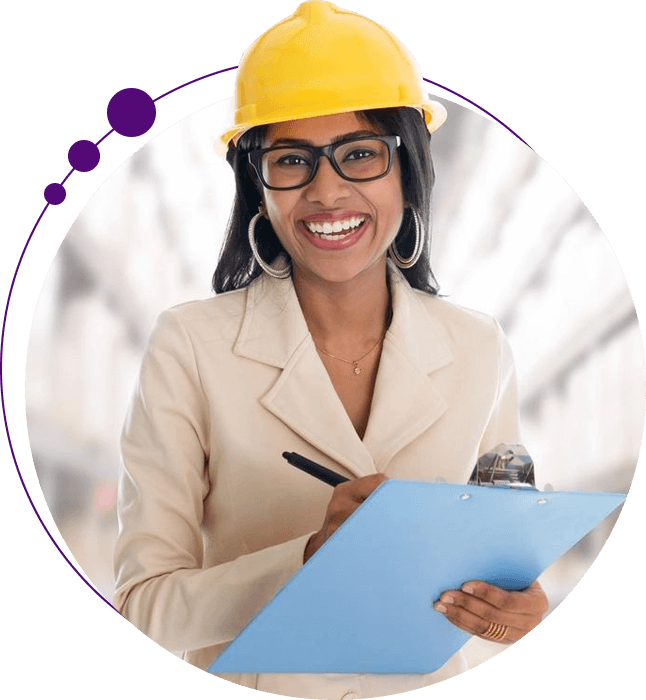 A woman in a hard hat holding a clipboard.