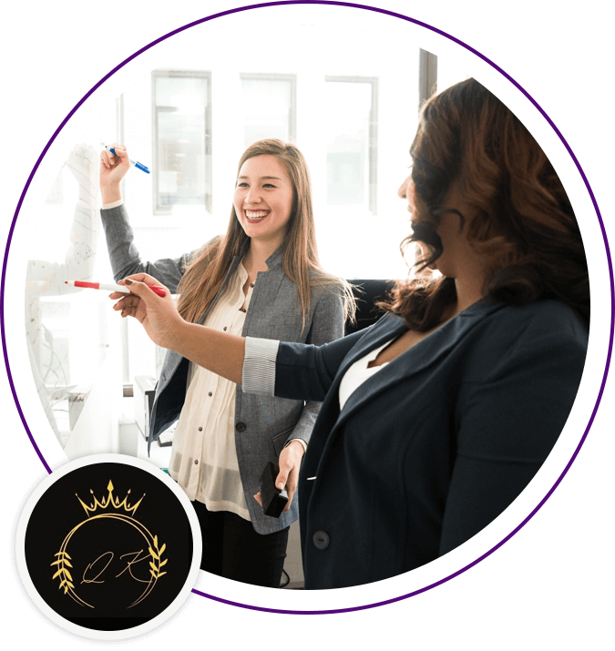 Two women are standing in a room and one is holding a marker